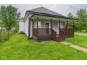 Charming home featuring a welcoming front porch, updated siding, and a well-maintained lawn at 1520 E Kirk St, Muncie, IN 47303