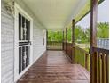 Inviting covered front porch with stained wood railings and trim, perfect for relaxing outdoors at 1520 E Kirk St, Muncie, IN 47303