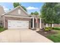 Beautiful brick home showcasing a well-kept lawn, a two-car garage, and a welcoming front entrance at 16573 Cava Dr, Fishers, IN 46037