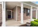 Covered front porch featuring white columns, brick accents, and an inviting entrance with sidelights at 16573 Cava Dr, Fishers, IN 46037