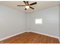 Cozy bedroom featuring hardwood floors, ceiling fan, and a window at 1661 S Talbott St, Indianapolis, IN 46225