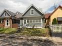 Charming home featuring gray siding, a well-kept lawn, and inviting front steps to the front door at 1661 S Talbott St, Indianapolis, IN 46225