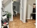 A bench with pillows and plant sits near an opening into a dining area with hardwood floors at 1661 S Talbott St, Indianapolis, IN 46225