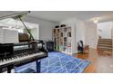 Cozy living room featuring a piano and hardwood flooring at 18915 Fairfield Blvd, Noblesville, IN 46060