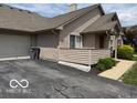 Property exterior featuring attached garage, trash receptacles, and concrete driveway at 3016 Wildcat Ln, Indianapolis, IN 46203