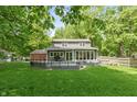 Backyard view featuring a spacious deck and lush lawn, perfect for outdoor entertaining at 3333 Melbourne S Rd, Indianapolis, IN 46228
