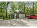 Detached garage with ample parking space and a red pickup truck nearby at 3333 Melbourne S Rd, Indianapolis, IN 46228