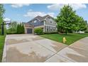 Exterior of a large, two-story home with a spacious driveway, three-car garage and landscaped yard at 3744 Abney Point Dr, Carmel, IN 46077