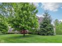 Well-maintained lawn with mature trees and landscaping surrounding a beautiful two-story home at 3744 Abney Point Dr, Carmel, IN 46077