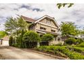 Beautiful two-story home featuring a brick facade, mature trees, and a well-maintained lawn at 3840 N Washington Blvd, Indianapolis, IN 46205