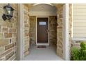 Inviting front door framed by stone archway and complementary sidelights at 4125 Sugar Pine Ln, Zionsville, IN 46077