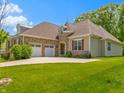 Beautiful home featuring a two-car garage, stone accents, and lush green lawn at 4125 Sugar Pine Ln, Zionsville, IN 46077