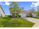 Inviting exterior elevation of a single-Gathering home with a well-manicured lawn and an attached two-car garage at 4181 Gordman Dr, Whitestown, IN 46075