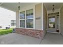 Charming front porch featuring brick accents, a large window, and a welcoming entrance to the home at 4181 Gordman Dr, Whitestown, IN 46075