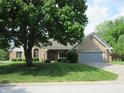 Traditional brick home featuring a well maintained lawn and an attached two car garage at 4288 Silver Hill Dr, Greenwood, IN 46142