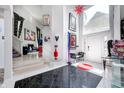Bright foyer with high ceilings, elegant decor, artistic accents, and black and white tile at 434 Sheffield Ct, Carmel, IN 46032