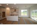 Spacious kitchen featuring ample sunlight, an island, and neutral tones at 5032 Carmine St, Brownsburg, IN 46112
