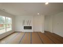 Bright living room featuring a sleek modern fireplace and large windows at 5032 Carmine St, Brownsburg, IN 46112