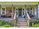 Cozy front porch with brick accents, a seating area, and decorative elements at 5758 N 1200 E, Sheridan, IN 46069