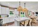 Bright, modern kitchen featuring white cabinets, quartz countertops, an island, and stainless steel appliances at 5931 Sterling Dr, Whitestown, IN 46075