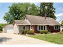 Charming brick home with attached garage and well-maintained landscaping at 6040 Manker St, Indianapolis, IN 46227