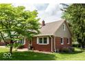 Well-maintained brick home with mature trees and landscaped grounds at 6040 Manker St, Indianapolis, IN 46227