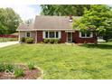 Well-maintained brick home featuring a spacious lawn and classic design at 6040 Manker St, Indianapolis, IN 46227