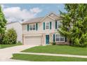 Lovely two-story home with a well-manicured lawn, mature trees, and a charming facade at 6703 Wimbledon Dr, Zionsville, IN 46077