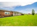 Beautiful lawn and front of house featuring an inviting front porch at 6863 W Jennifer Ct, Greenfield, IN 46140