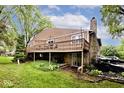 Exterior view of a two-story home with a large wooden deck and a stone foundation at 8024 Sunfield Ct # 5-B, Indianapolis, IN 46214