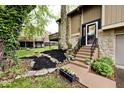 Inviting home entrance with stone accents, flower beds, and well-maintained landscaping at 8024 Sunfield Ct # 5-B, Indianapolis, IN 46214