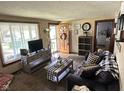 Inviting living room with wood-look flooring, a neutral color scheme, and natural light from a large window at 852 Walnut St, Greenfield, IN 46140