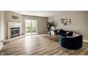 Bright and inviting living room with a fireplace, sliding doors, and stylish furniture at 8690 Jaffa Ct W Dr # 28, Indianapolis, IN 46260