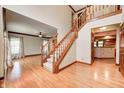 Spacious foyer boasts hardwood floors, staircase with carpet, and views into the living and kitchen areas at 9158 Oak Knoll Ln, Fishers, IN 46037