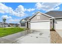 Lovely single-Gathering home with a two-car garage, long driveway, and manicured landscaping at 104 Maxim Ct, Cumberland, IN 46229