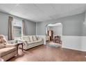 Cozy living room with hardwood floors, neutral paint, and an archway to adjacent room at 1124 S Lockburn St, Indianapolis, IN 46241