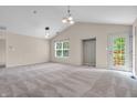 Spacious living room featuring neutral walls, high ceilings, a large window, and sliding glass doors at 1139 Fernwood Way, Plainfield, IN 46168