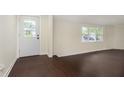 Inviting entryway with rich hardwood floors and a bright white front door at 125 S Alfonte St, Ingalls, IN 46048