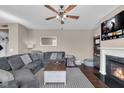 Inviting living room features a comfortable gray sectional sofa, fireplace, and view of the outdoors at 1381 Avocet Dr, Greenwood, IN 46143
