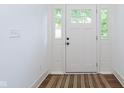 Bright entryway featuring a white front door with sidelights, enhancing natural light and curb appeal at 1502 Burdsal Pkwy, Indianapolis, IN 46208