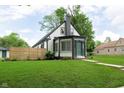 Charming home showcasing its manicured lawn, inviting curb appeal, and well-maintained exterior at 1502 Burdsal Pkwy, Indianapolis, IN 46208