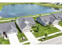 Scenic aerial view of a home with a pond in a neighborhood at 1530 Gristmill Meadows Dr, Westfield, IN 46074