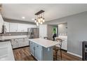 Bright kitchen with white cabinets, stainless steel appliances, an island, and lots of counterspace at 2 E Quail Wood Ln, Westfield, IN 46074