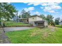 Ranch home featuring an attached garage, play area, and landscaped yard at 313 E South St, Morristown, IN 46161