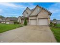 Beautiful two-story brick home with a well-maintained lawn, established landscaping, and a spacious driveway at 3247 Moonlight Ct, Columbus, IN 47203