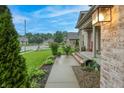 Charming home exterior showcasing a well-manicured lawn, established landscaping, and inviting walkway to the front door at 3247 Moonlight Ct, Columbus, IN 47203