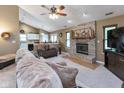 Open-concept living room featuring a fireplace, vaulted ceiling, and view of the kitchen at 3630 Foxtail Dr, Indianapolis, IN 46235