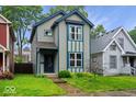 Charming two-story home with blue trim and a well-manicured lawn, perfect for a Gathering at 3658 Graceland Ave, Indianapolis, IN 46208