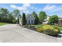 Charming single-story home with a long driveway, manicured landscaping, and a spacious three-car garage at 3815 Harrison Crossing Ln, Greenwood, IN 46142