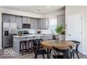 Modern kitchen with gray cabinets, stainless steel appliances, and an island at 3899 Sterling Dr, Whitestown, IN 46075